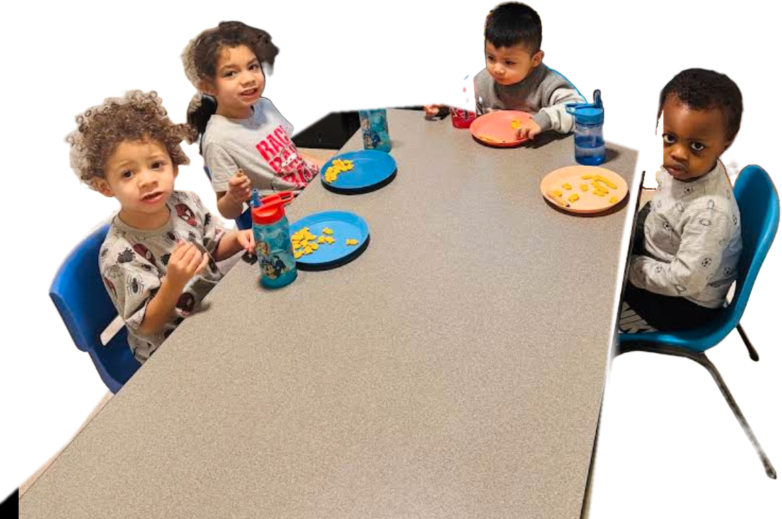 Children enjoying a healthy snack together at the table at Eman Home Child Care